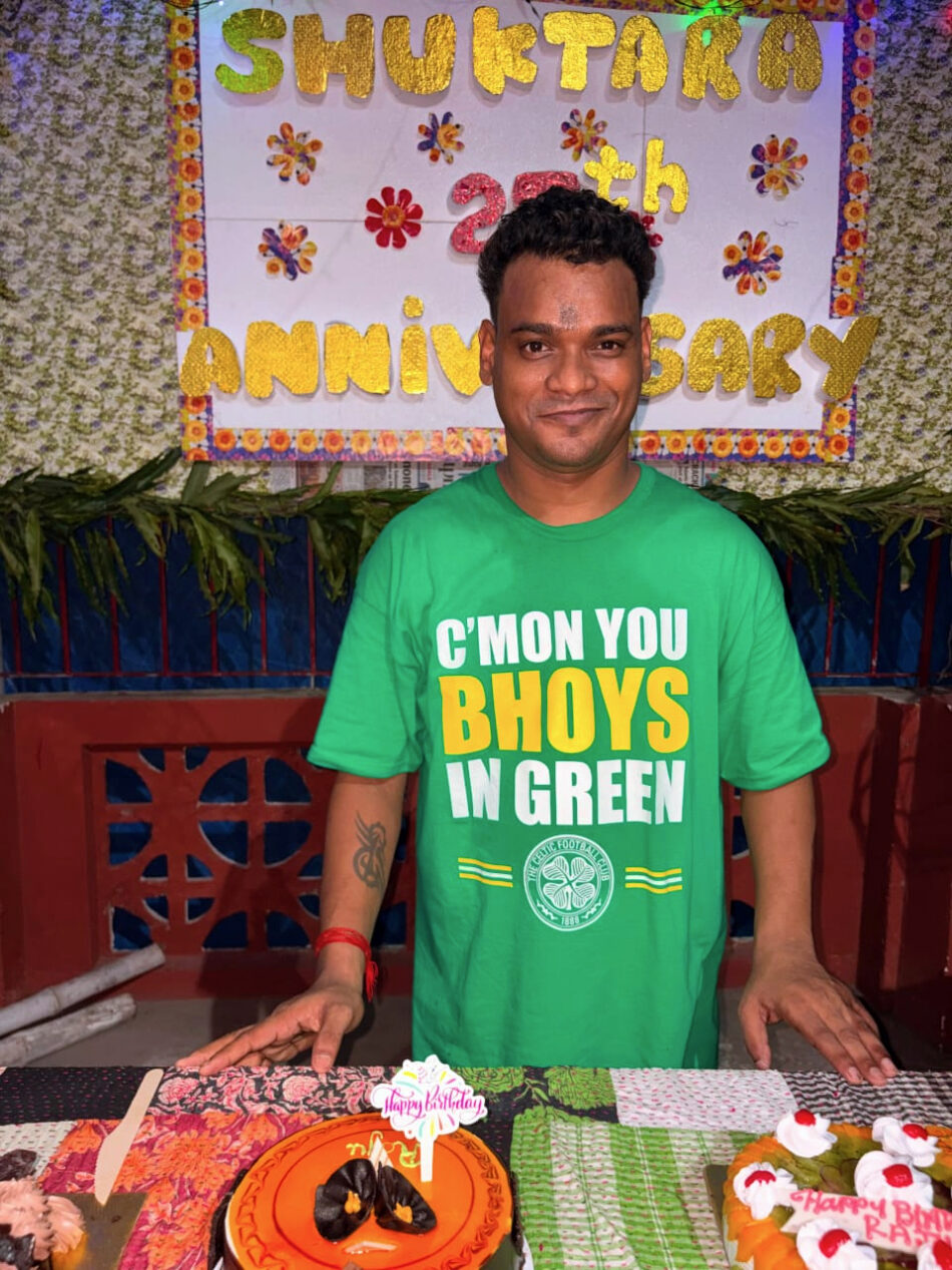 young man with green shirt standing