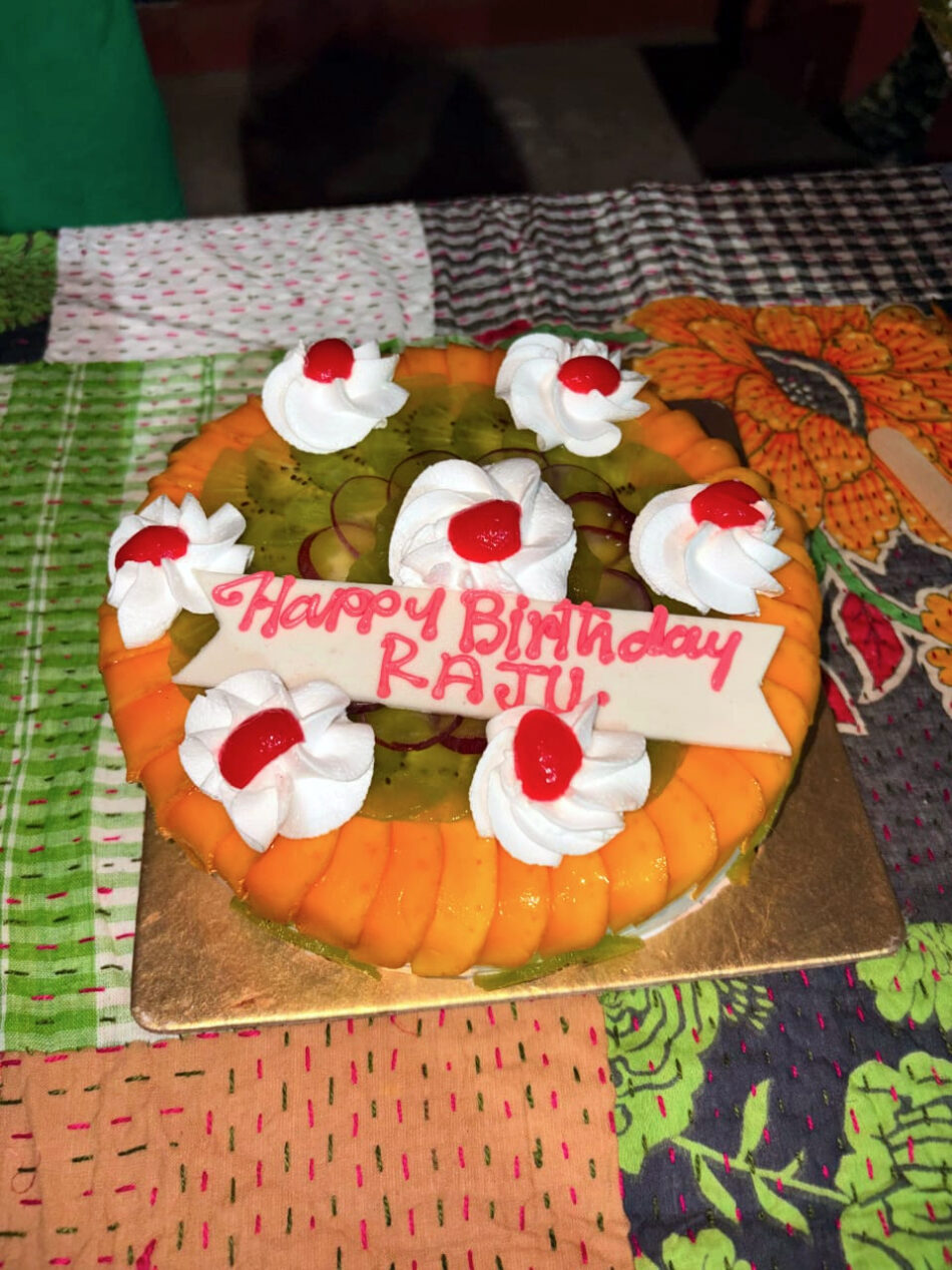 cake with Happy Birthday Raju written with icing