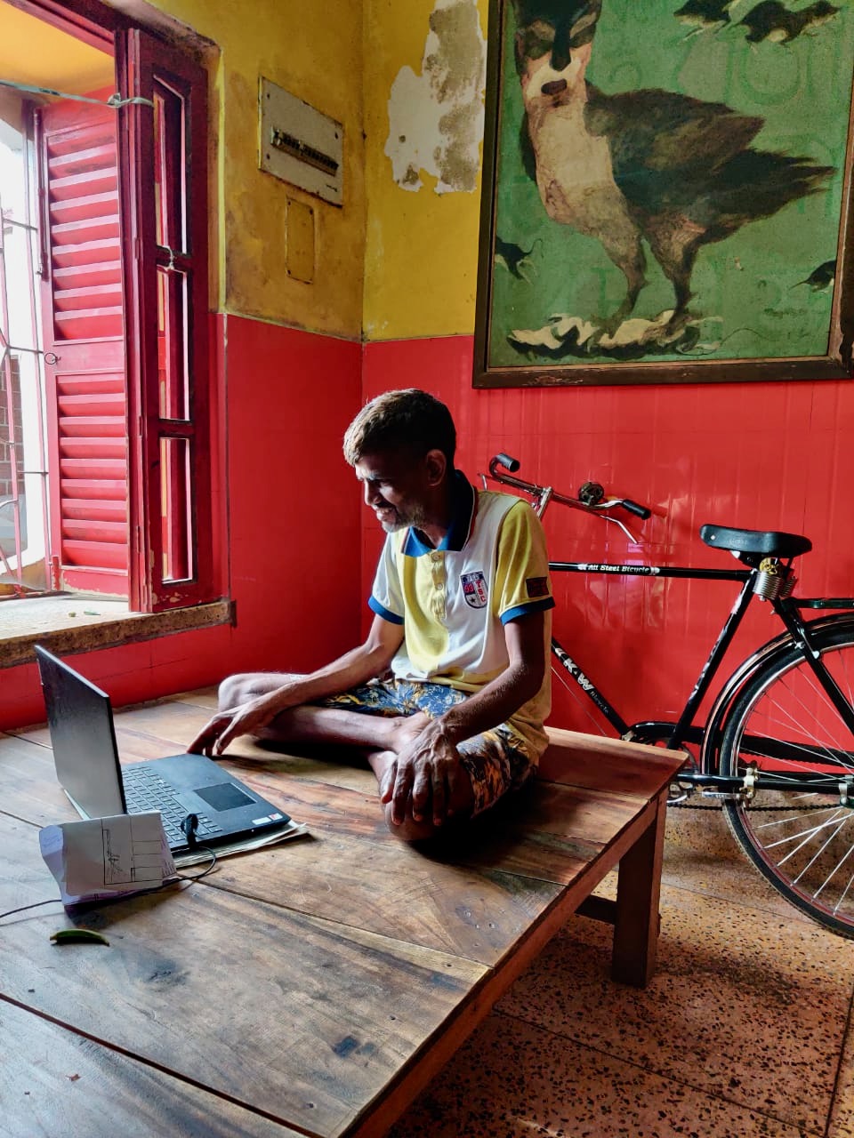 shuktara - Sunil sitting in front of a laptop
