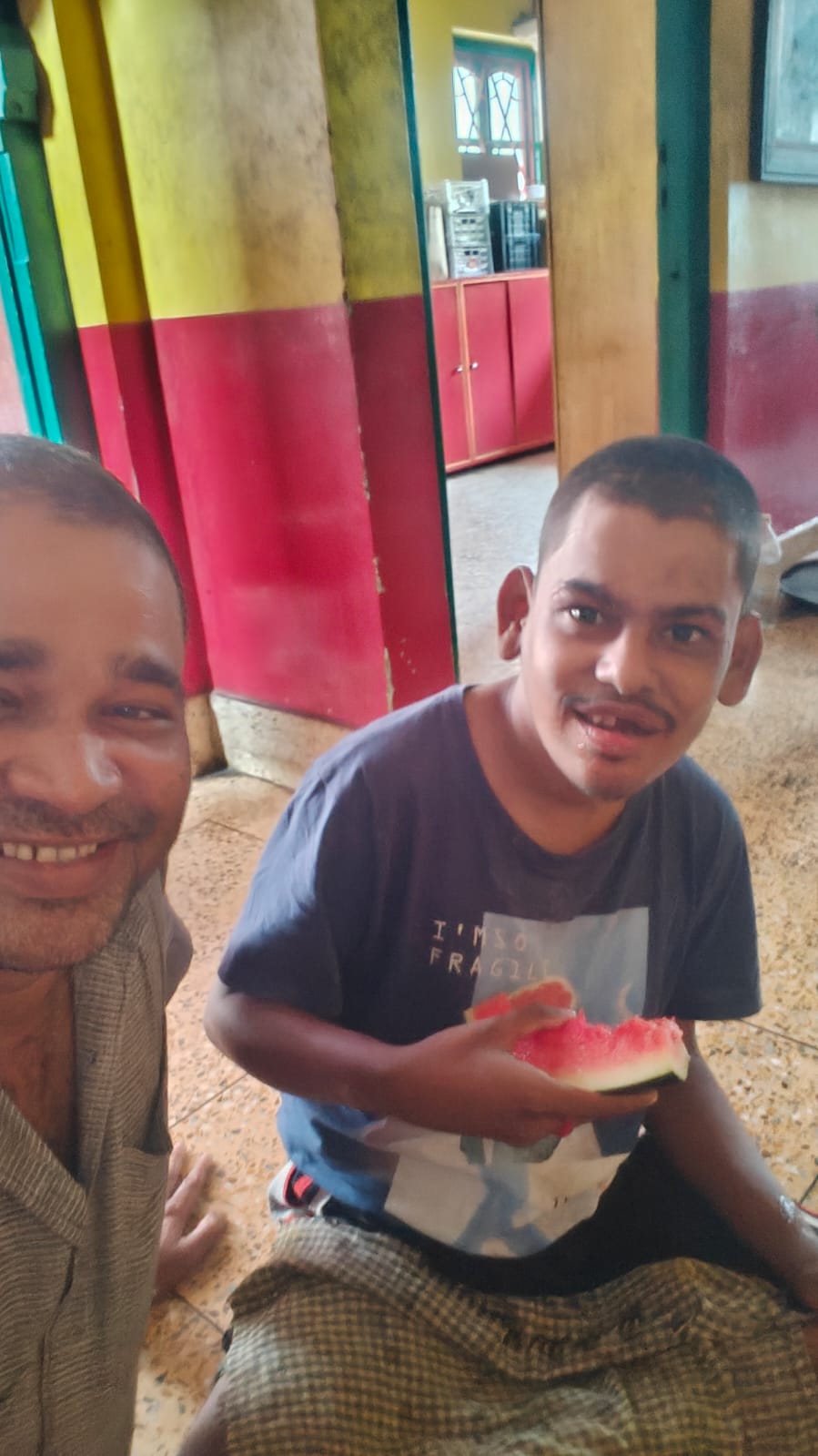 Boy with disabilities smiling tentatively