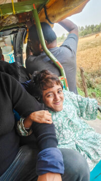 smiling young women in open vehicle in countryside