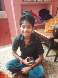 young woman with short dark hair seated