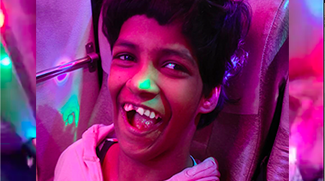 young girl's face with pink and green lights
